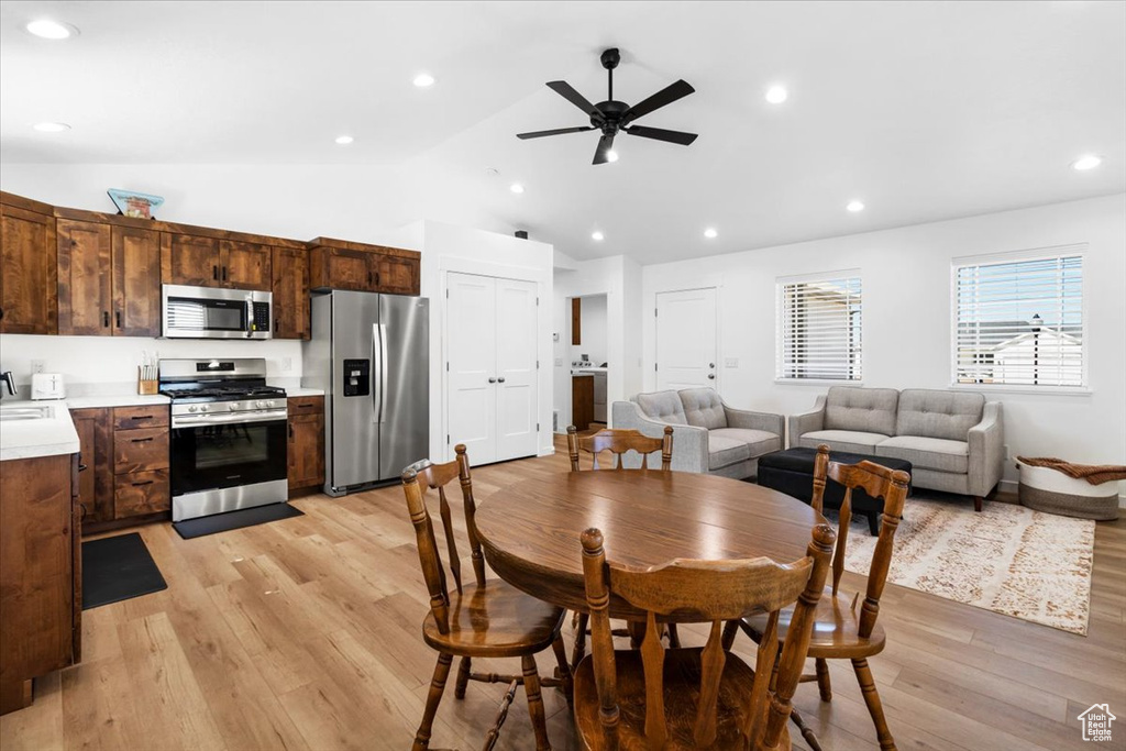 Dining room with a ceiling fan, lofted ceiling, recessed lighting, and light wood finished floors