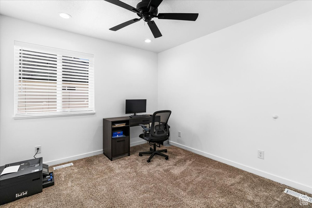Office featuring baseboards, ceiling fan, carpet flooring, and visible vents