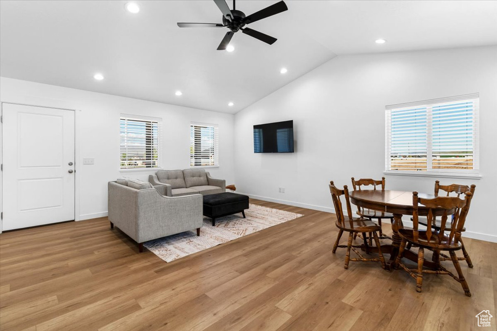 Living area with ceiling fan, light wood-type flooring, baseboards, lofted ceiling, and recessed lighting