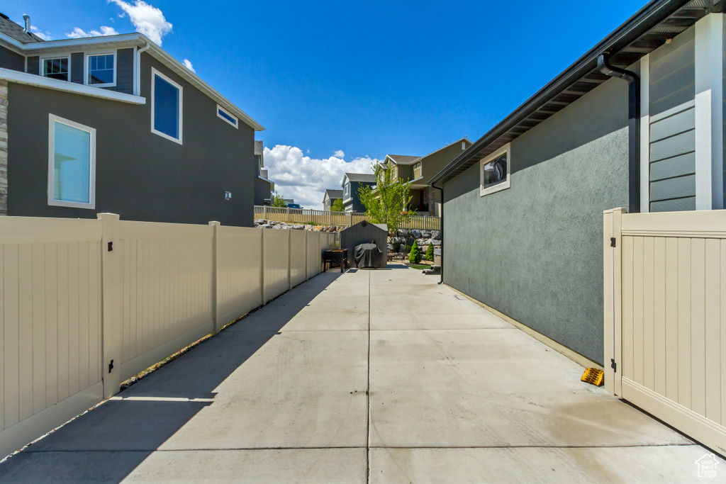 View of home\'s exterior with fence, a patio, stucco siding, and a residential view