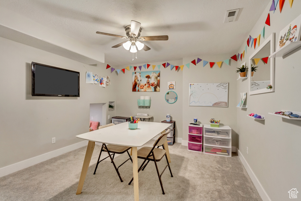 Recreation room featuring visible vents, a ceiling fan, baseboards, and light carpet