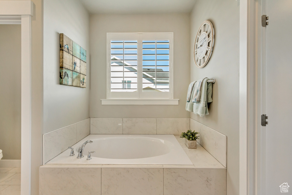 Bathroom featuring a bath and toilet