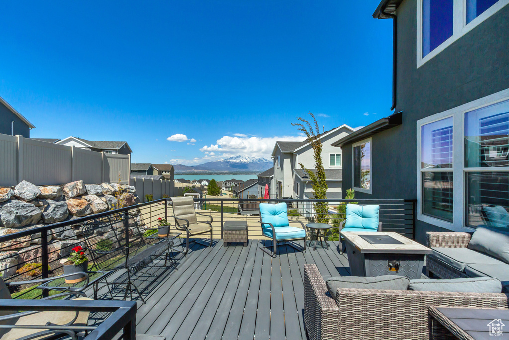 Wooden deck with a mountain view and an outdoor living space with a fire pit