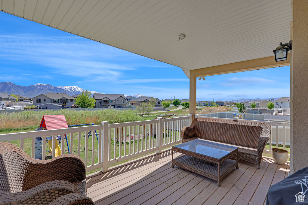 Wooden deck with a mountain view and a residential view