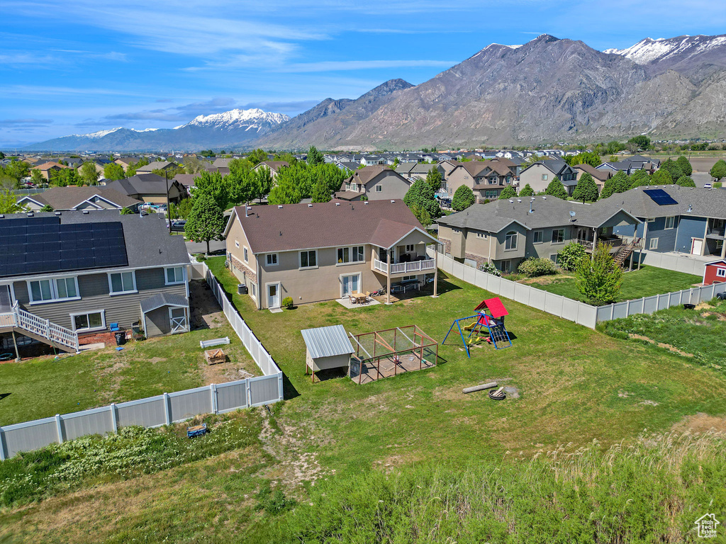 Birds eye view of property with a mountain view and a residential view
