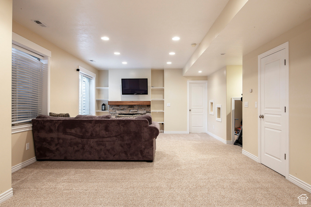Living room featuring baseboards, light carpet, and recessed lighting