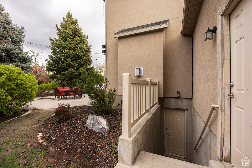 View of home\'s exterior featuring stucco siding and a patio area