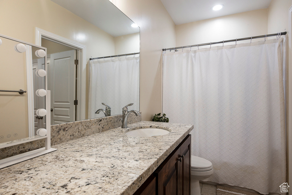 Full bath with recessed lighting, vanity, and toilet