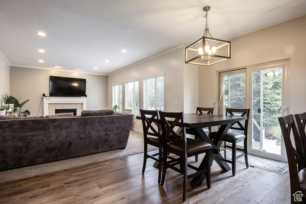 Dining area featuring crown molding, a wealth of natural light, and wood finished floors