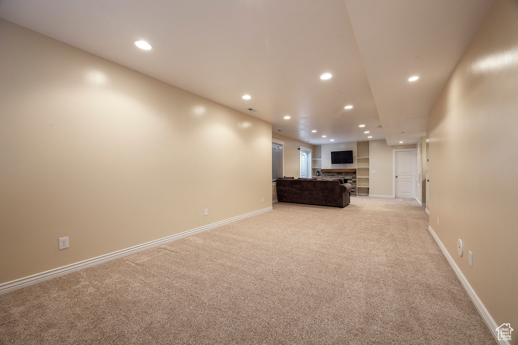Unfurnished living room featuring recessed lighting, baseboards, and light colored carpet