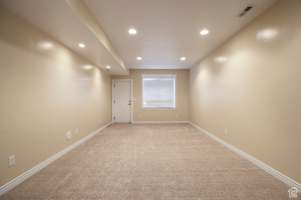 Empty room with baseboards, light carpet, recessed lighting, and visible vents