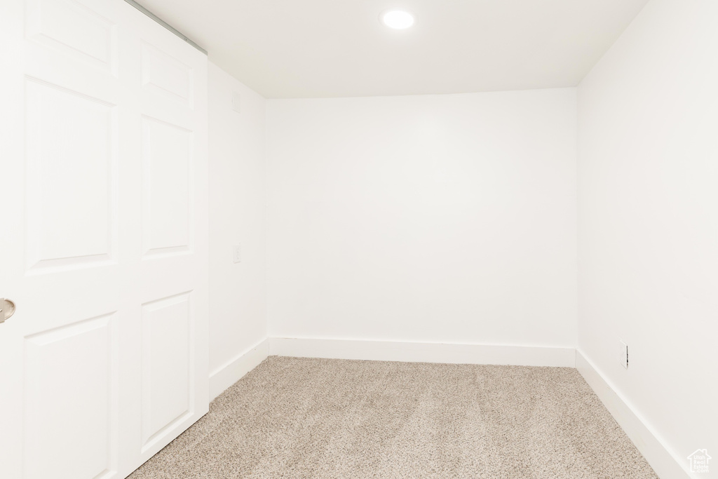 Unfurnished room with recessed lighting, baseboards, and light carpet