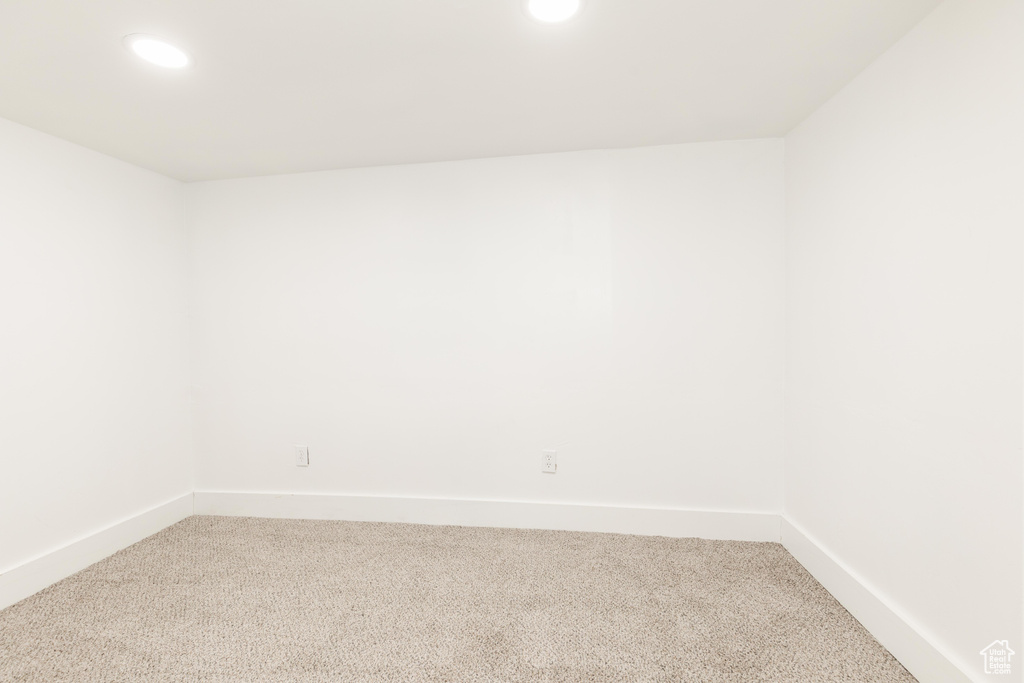 Unfurnished room with recessed lighting, baseboards, and light carpet