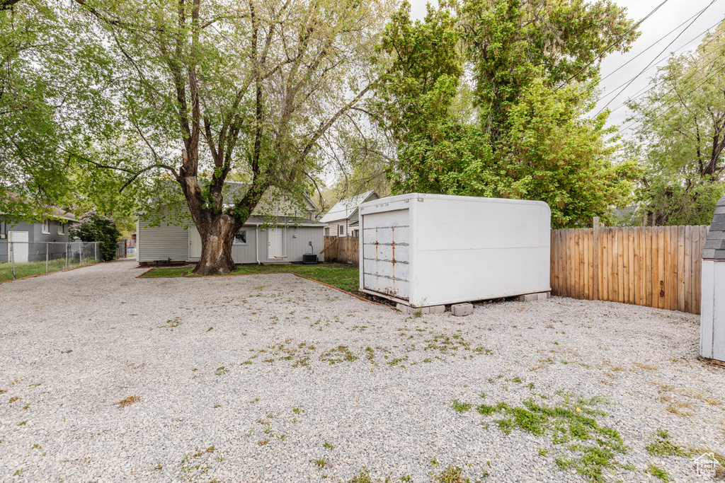 View of yard featuring an outdoor structure, a shed, and a fenced backyard