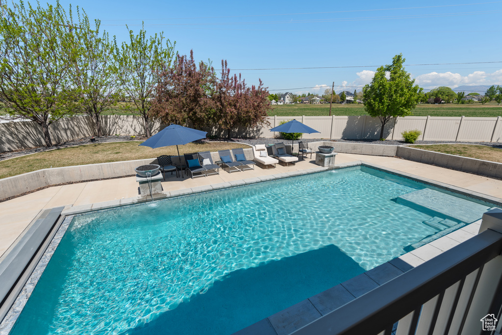 View of pool featuring a fenced in pool, a fenced backyard, and a patio area