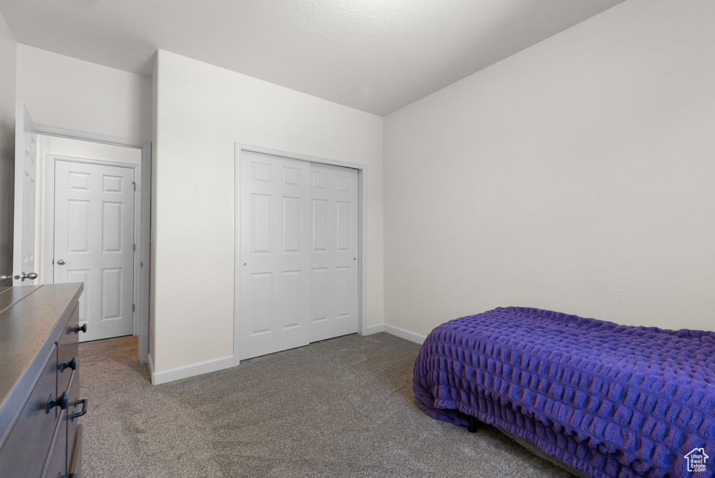 Carpeted bedroom featuring baseboards