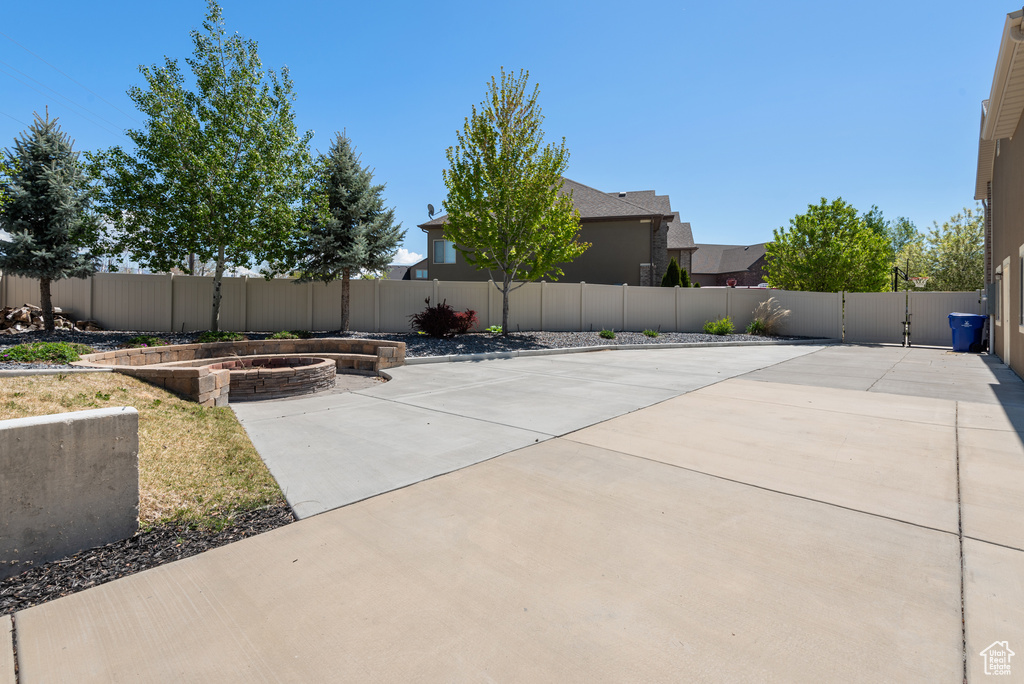 View of patio with a fenced backyard and a vegetable garden