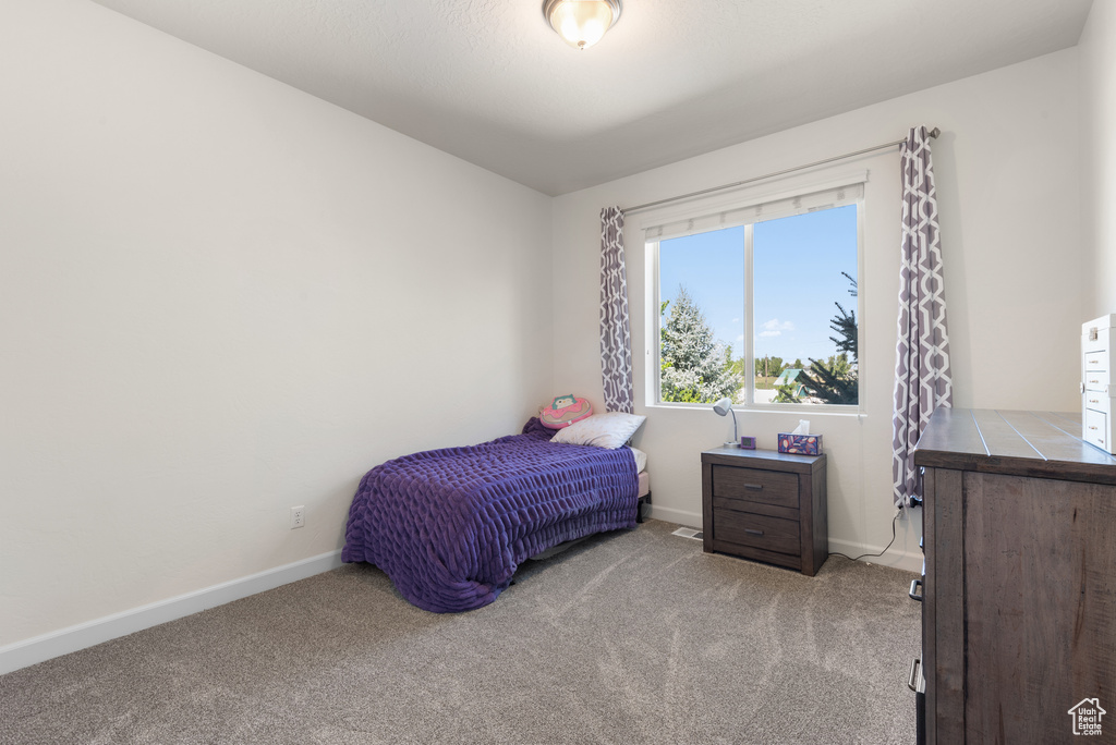 Carpeted bedroom featuring baseboards