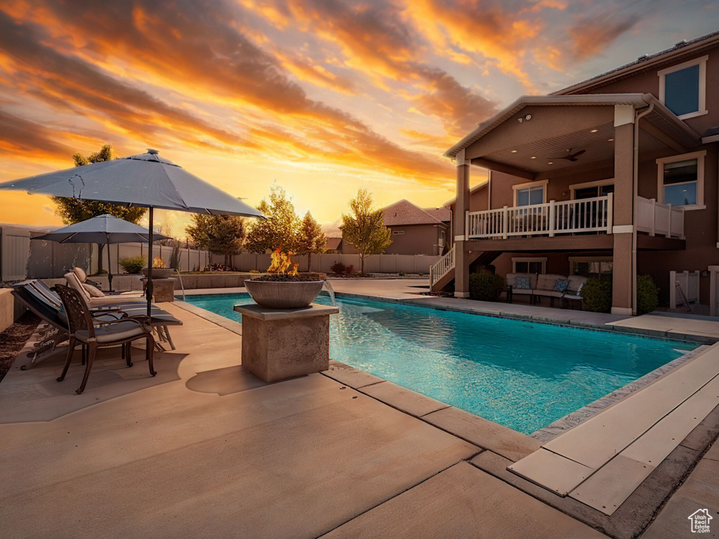 View of swimming pool with stairs, ceiling fan, a fenced backyard, a fenced in pool, and a patio area