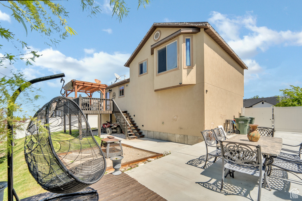 Back of house with fence, a pergola, a wooden deck, a patio, and stairs
