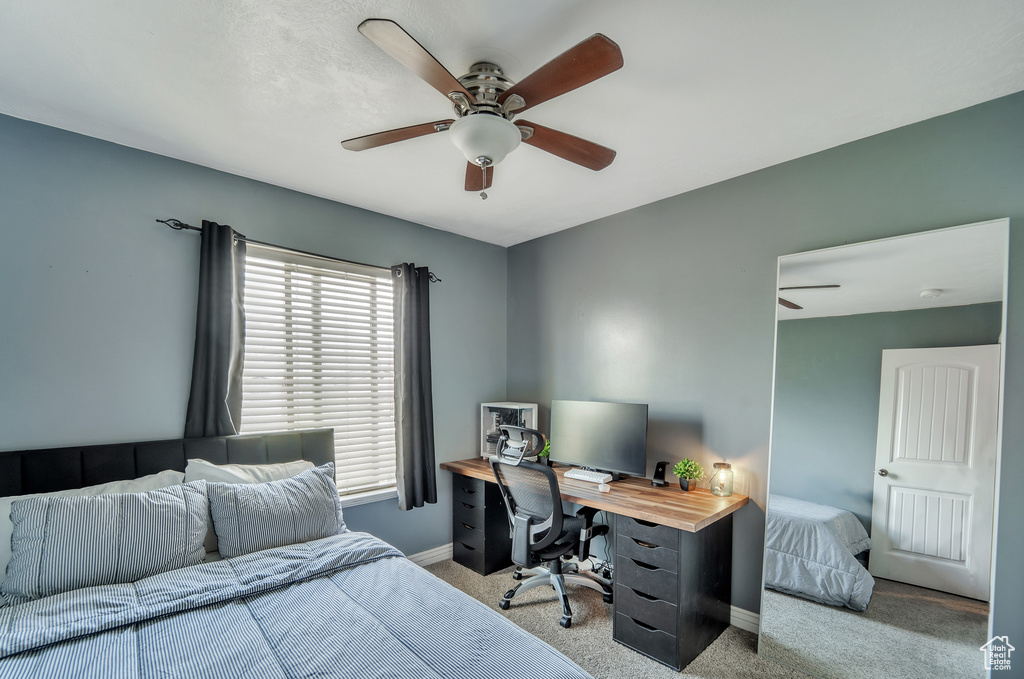 Bedroom featuring baseboards, carpet flooring, and ceiling fan