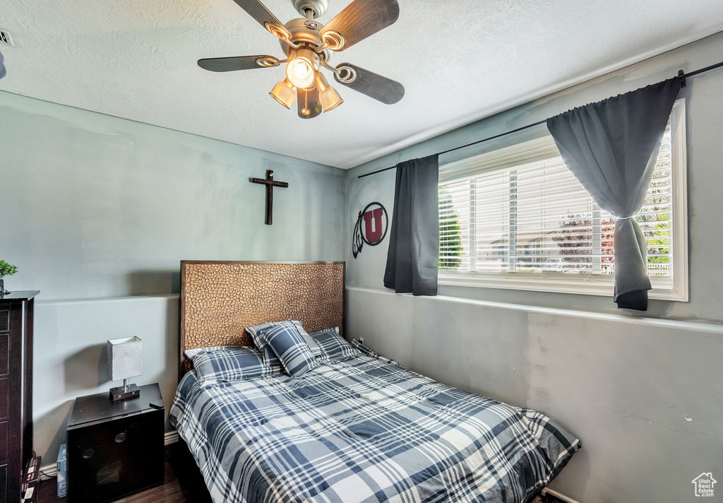 Bedroom with ceiling fan and wood finished floors