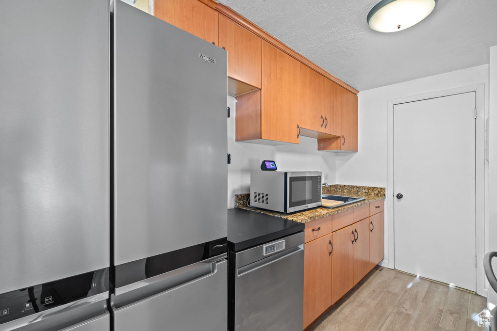 Kitchen featuring light wood-style flooring and stainless steel appliances