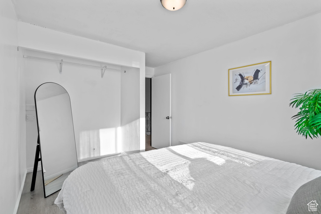 Bedroom with baseboards and wood finished floors