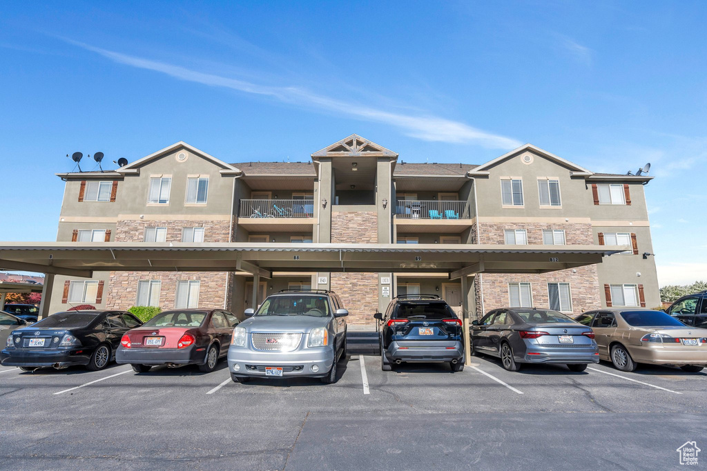 View of building exterior with covered parking