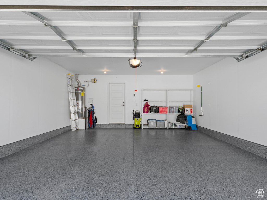 Garage with a garage door opener and secured water heater