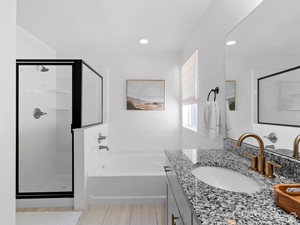 Full bathroom with vanity, a stall shower, recessed lighting, and a bath