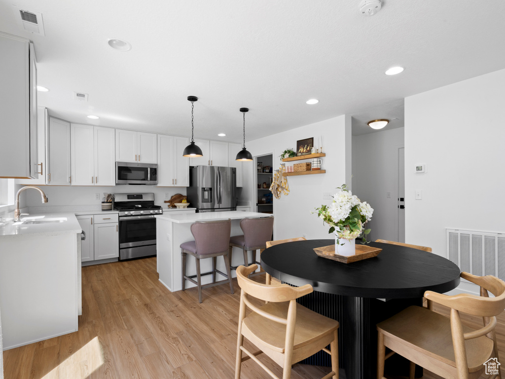 Dining room with recessed lighting, visible vents, and light wood-type flooring