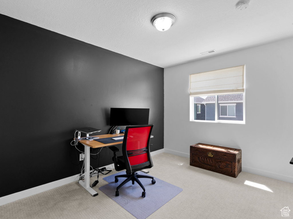 Carpeted home office with baseboards