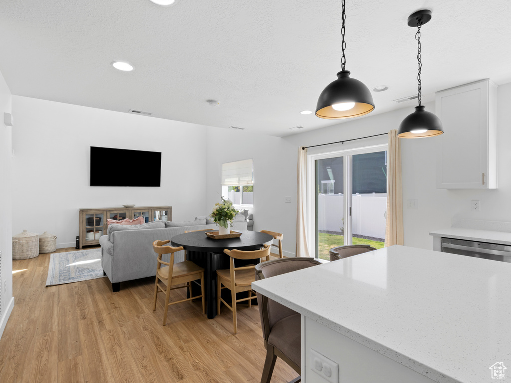 Dining area featuring recessed lighting, light wood finished floors, and visible vents