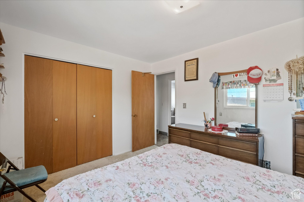 Bedroom with carpet floors and a closet