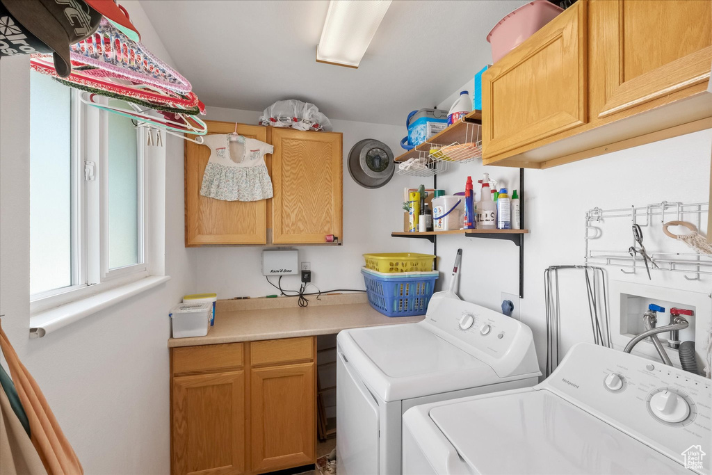 Laundry area with cabinet space and washing machine and dryer