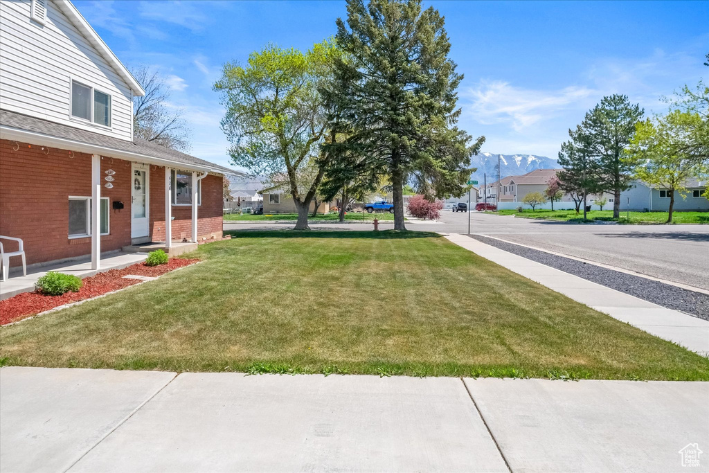 View of yard with a porch and a residential view