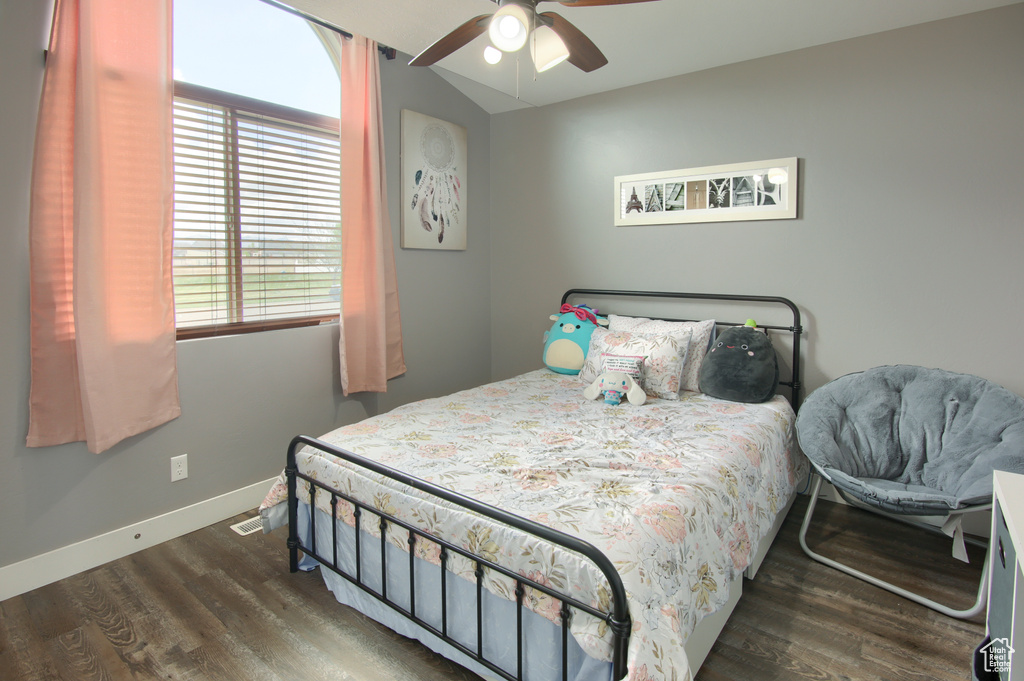 Bedroom featuring a ceiling fan, baseboards, and wood finished floors