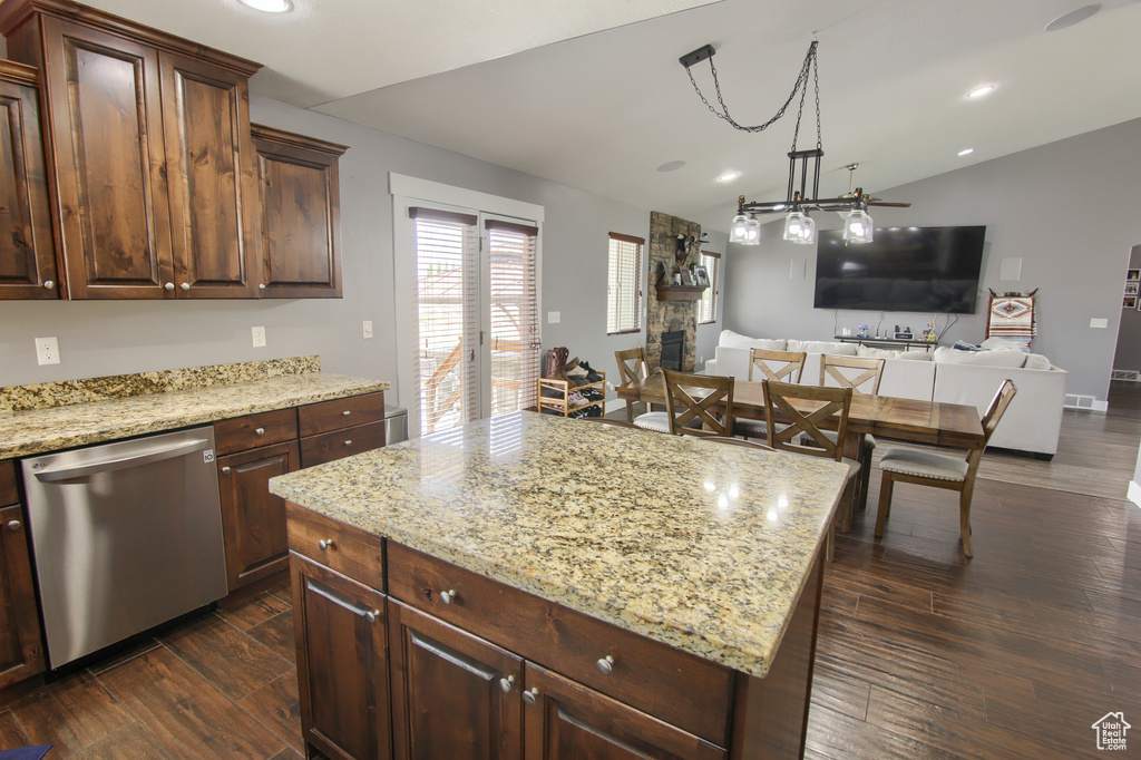 Kitchen with open floor plan, recessed lighting, dark wood finished floors, dishwasher, and vaulted ceiling