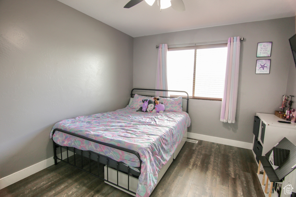Bedroom featuring baseboards, ceiling fan, and wood finished floors