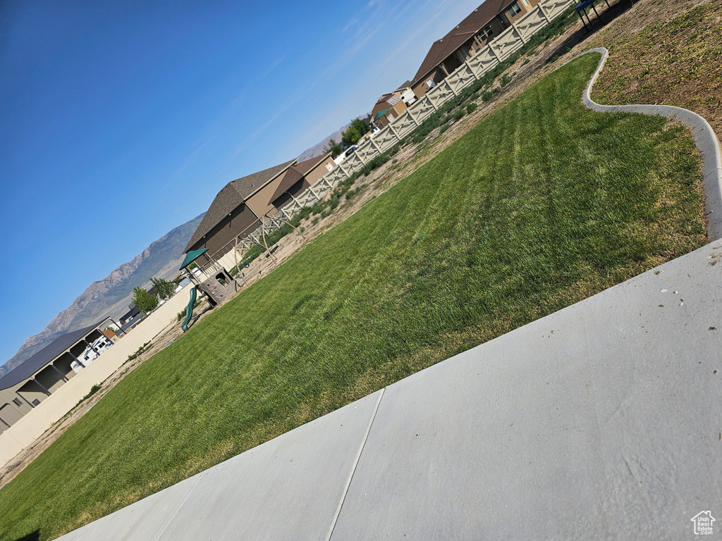 View of grassy yard with a mountain view