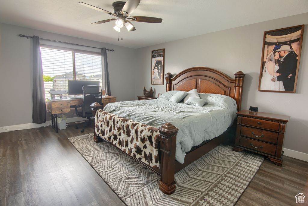 Bedroom featuring baseboards, a ceiling fan, and dark wood-style floors