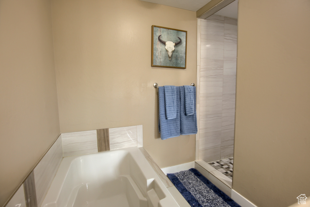 Full bath featuring a stall shower and a bath