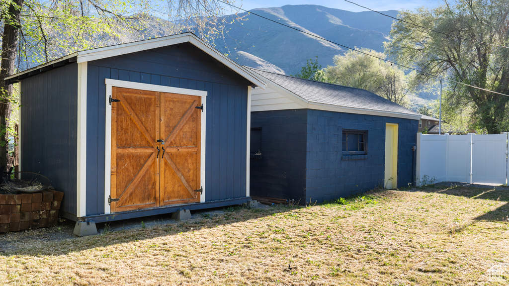 View of shed featuring fence and a mountain view