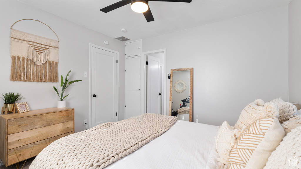 Bedroom with a ceiling fan and visible vents