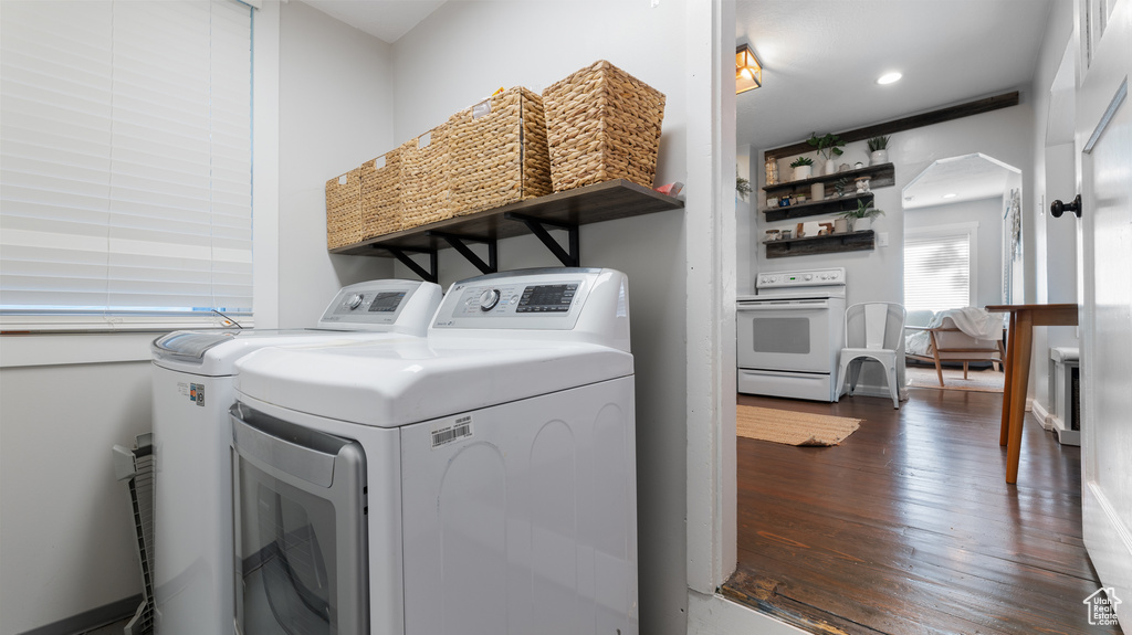 Laundry area with laundry area, washer and clothes dryer, and dark wood-style flooring