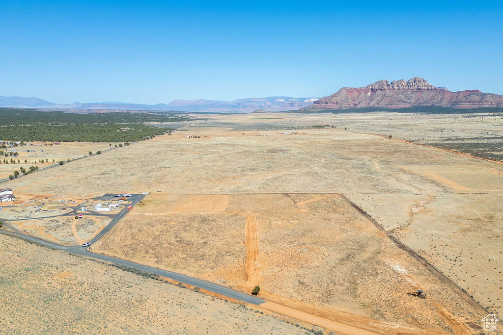Drone / aerial view featuring view of desert and a rural view