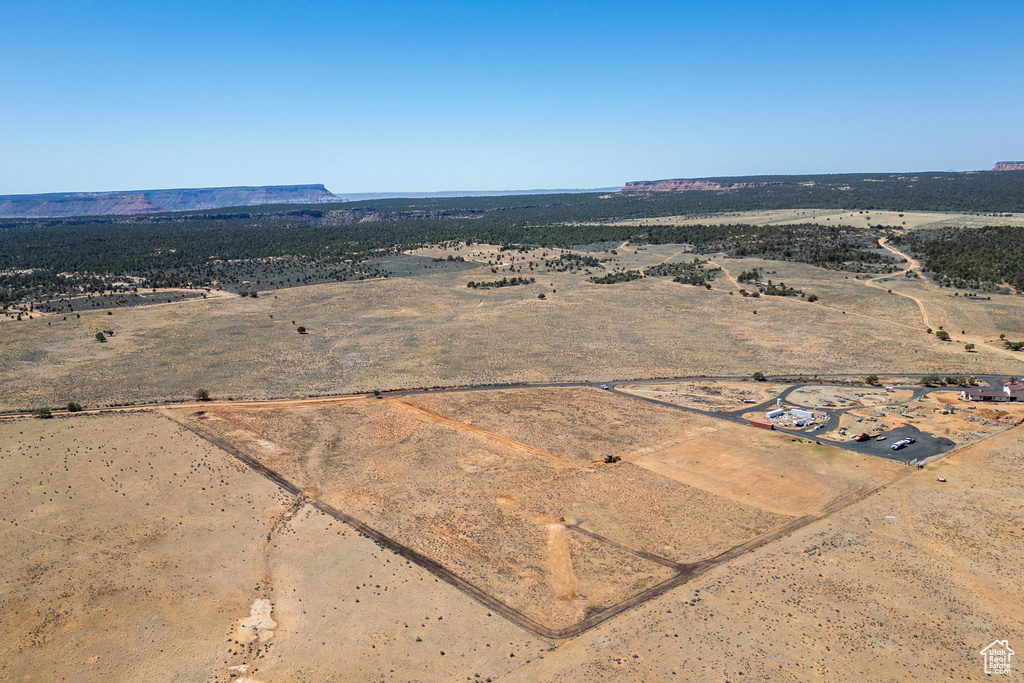 Aerial view featuring view of desert and a rural view