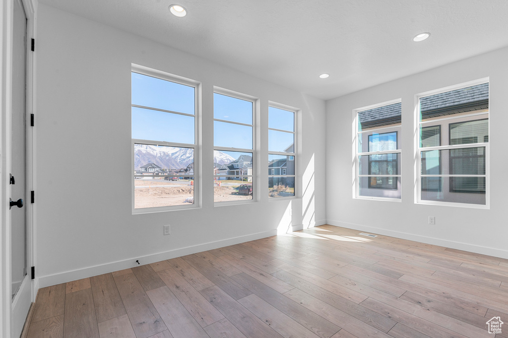 Empty room featuring recessed lighting, baseboards, and light wood finished floors