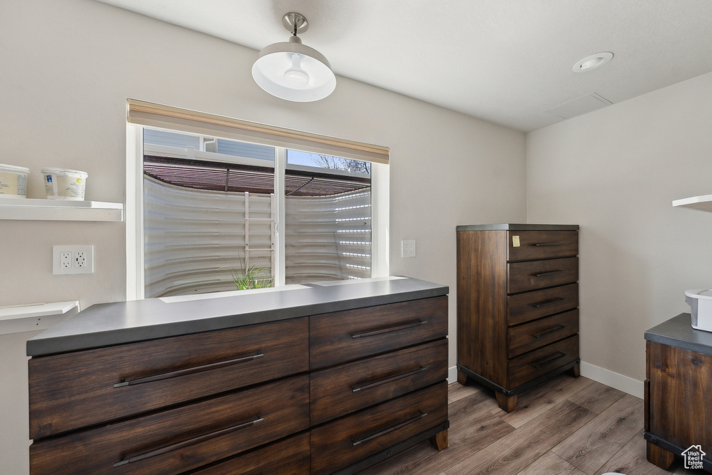 Bedroom featuring wood finished floors and baseboards